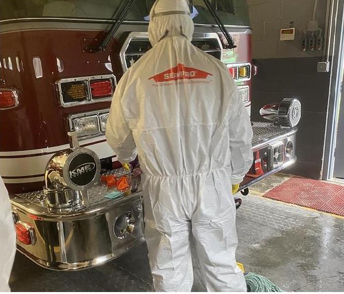 SERVPRO tech in PPE cleaning fire truck