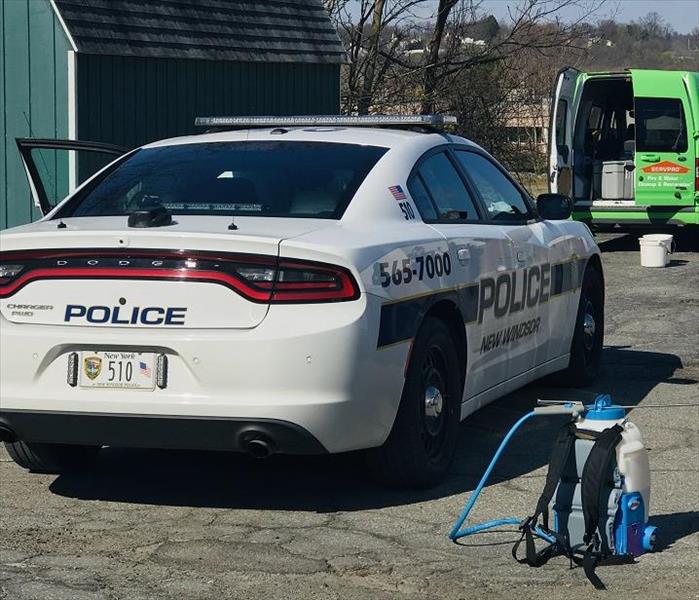 Police car behind SERVPRO van