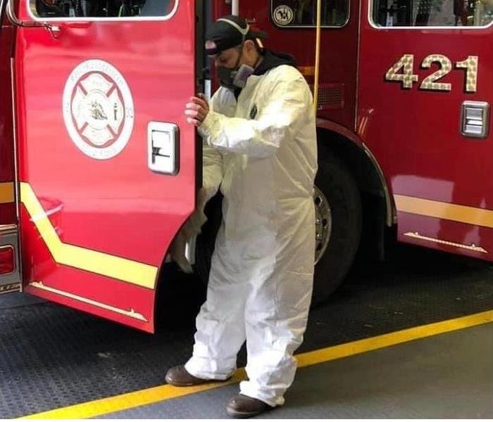 SERVPRO tech in PPE cleaning fire truck