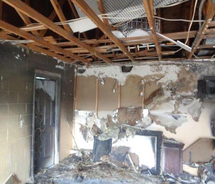  Fire damaged room with cinderblock walls and debris