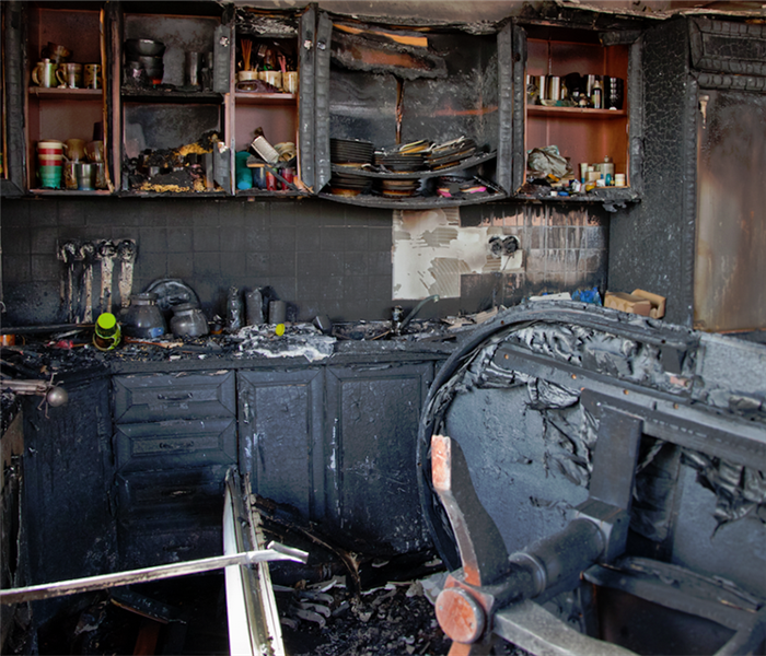 fire damaged kitchen with soot covering everything