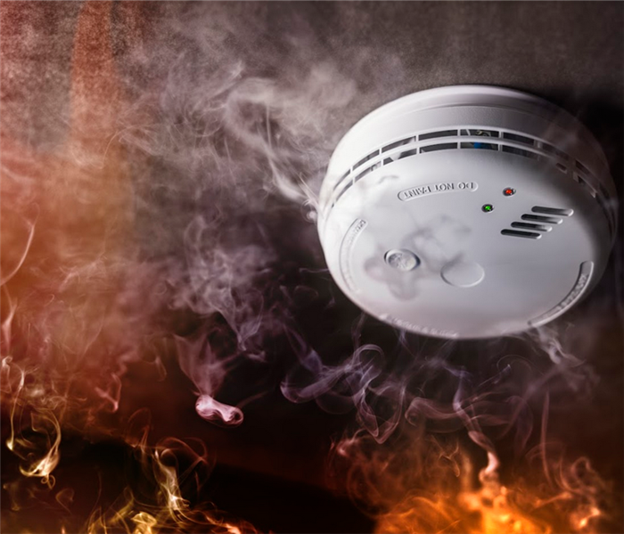 a smoke detector with fire around it