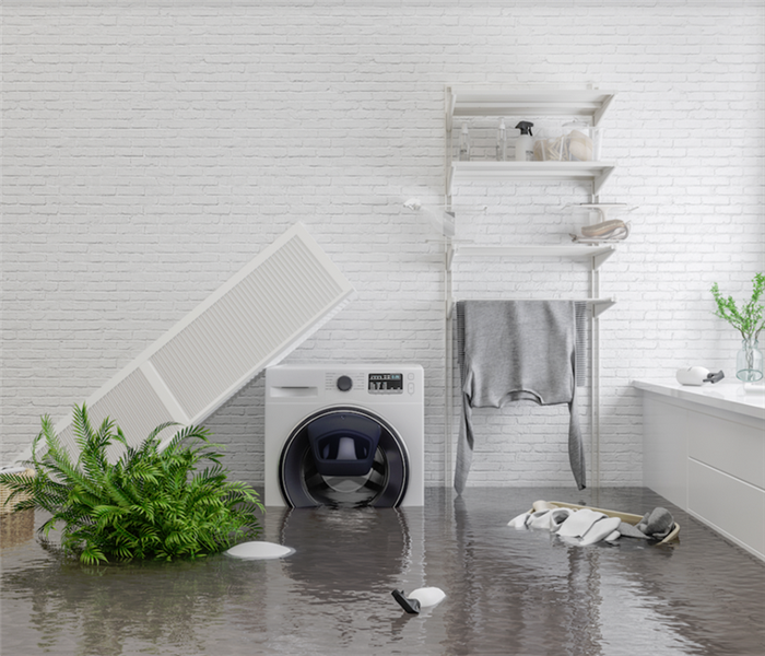 a flooded laundry room with items floating everywhere