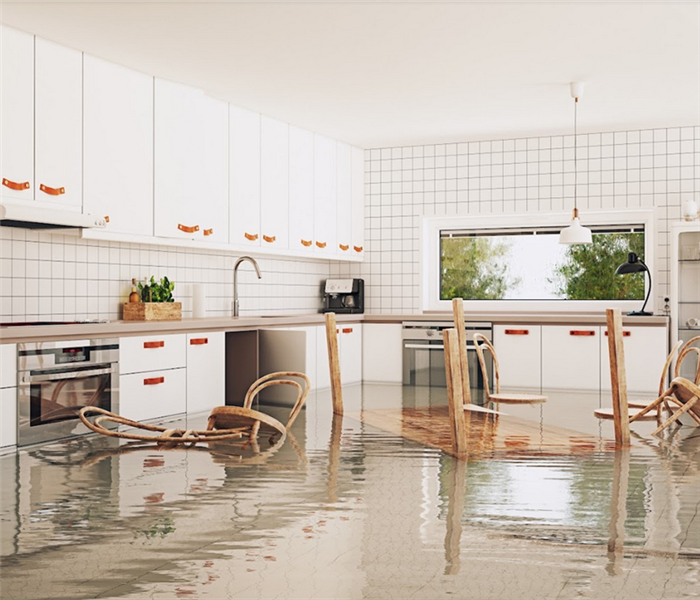 a flooded kitchen with furniture floating everywhere