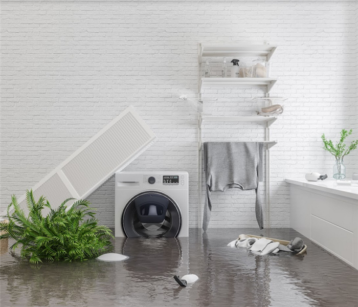 a flooded laundry room with water covering the floors