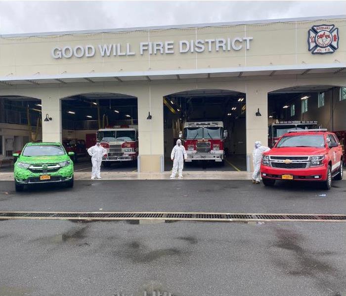 SERVPRO car and three technicians in front of a Fire department